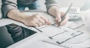 man drawing home plans
