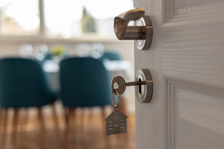 key in door with metal house keychain